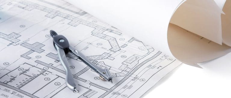 Architectural plans compass and ruler on the desk